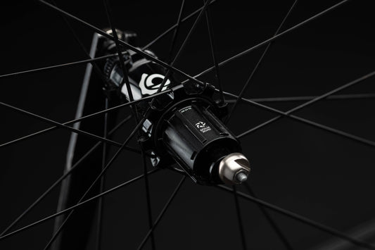Close-up of a bicycle hub with visible branding on a black background