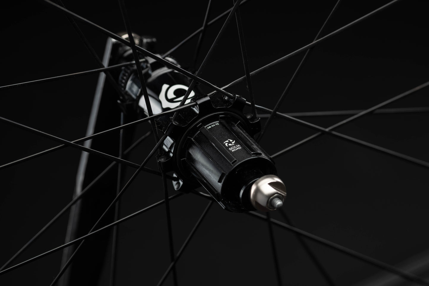 Close-up of a bicycle hub with visible branding on a black background