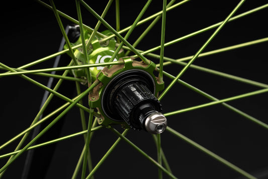 Close-up of a lime bicycle wheel with a black background