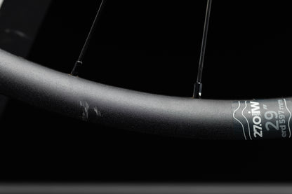 Close-up of a bicycle rim with a brand label on a black background