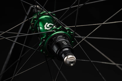 Close-up of a green bicycle hub with a black background