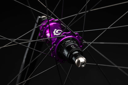 Close-up of a purple bicycle hub with black background